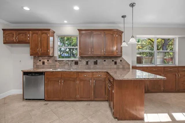a bathroom with a granite countertop toilet and a sink