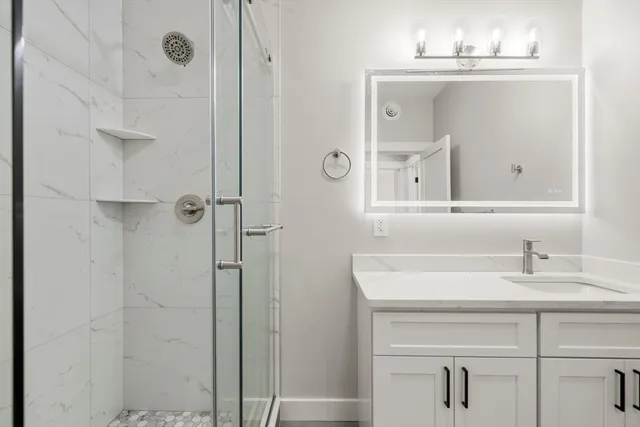 a bathroom with a sink vanity and a mirror