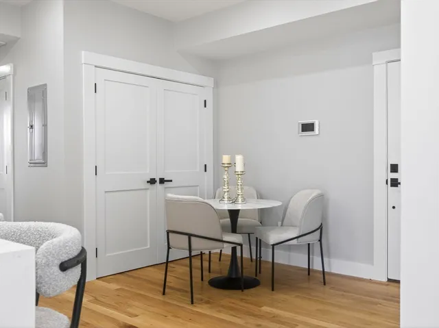 a view of a room with furniture and wooden floor