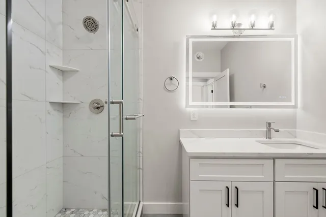 a bathroom with a sink vanity and a mirror