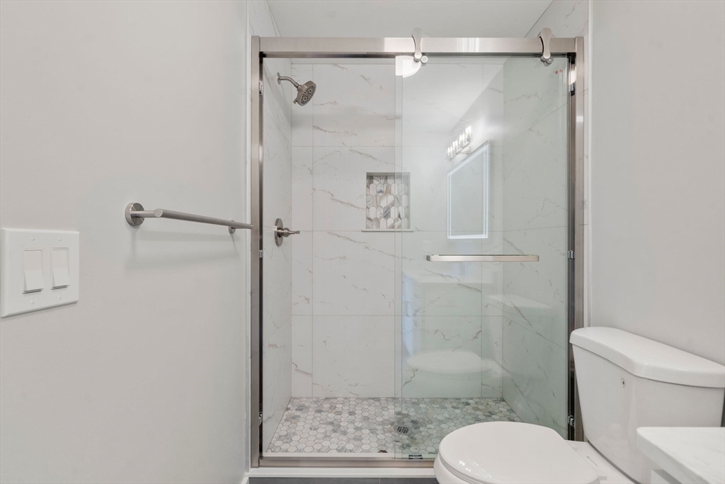 60 Stanley Street, Unit 101 Boston, MA 02125 - Photo 9 of 11 a bathroom with a shower and toilet