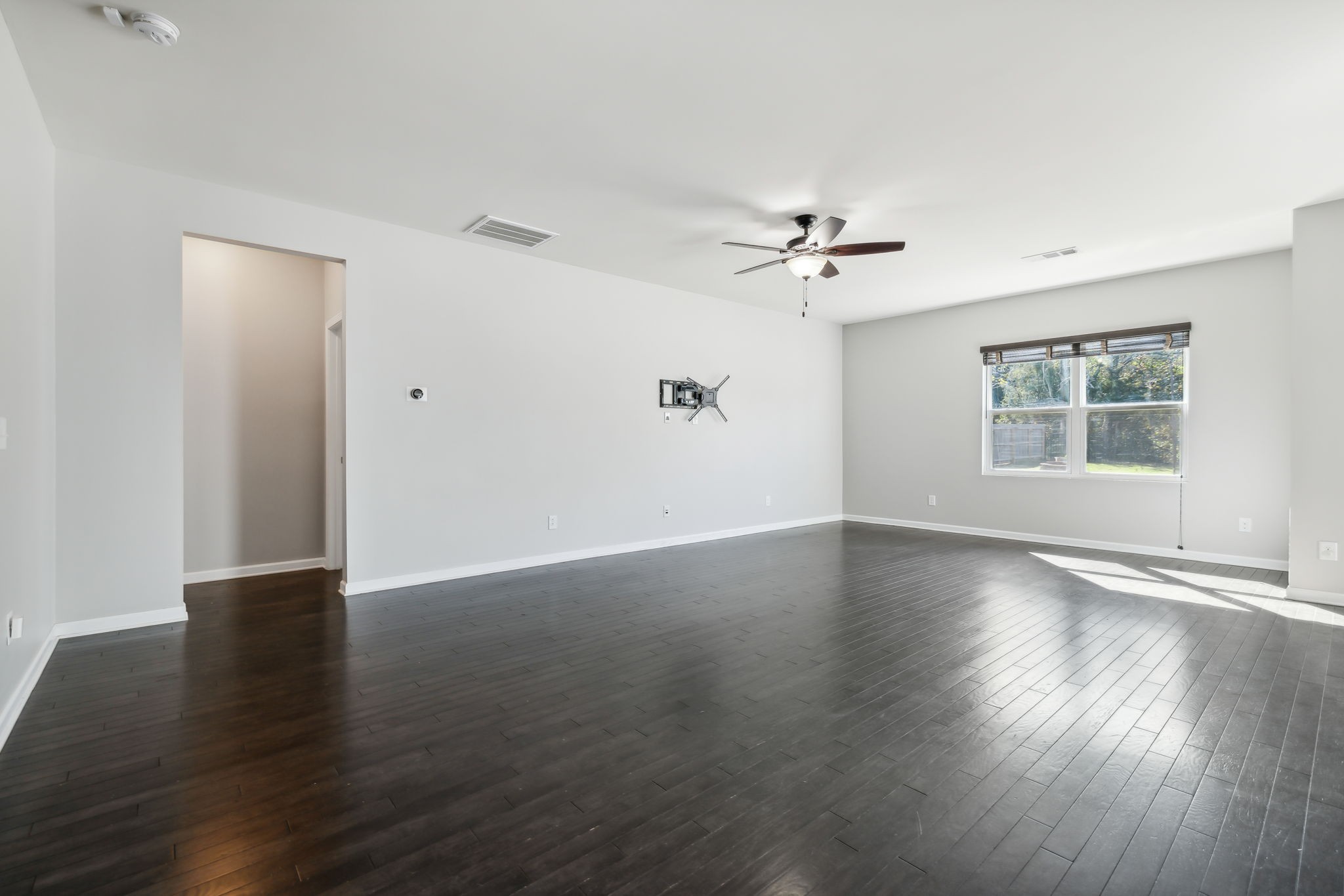 1408 Old Stone Road Lebanon, TN 37087 - Photo 7 of 31 a view of an empty room with wooden floor and a window