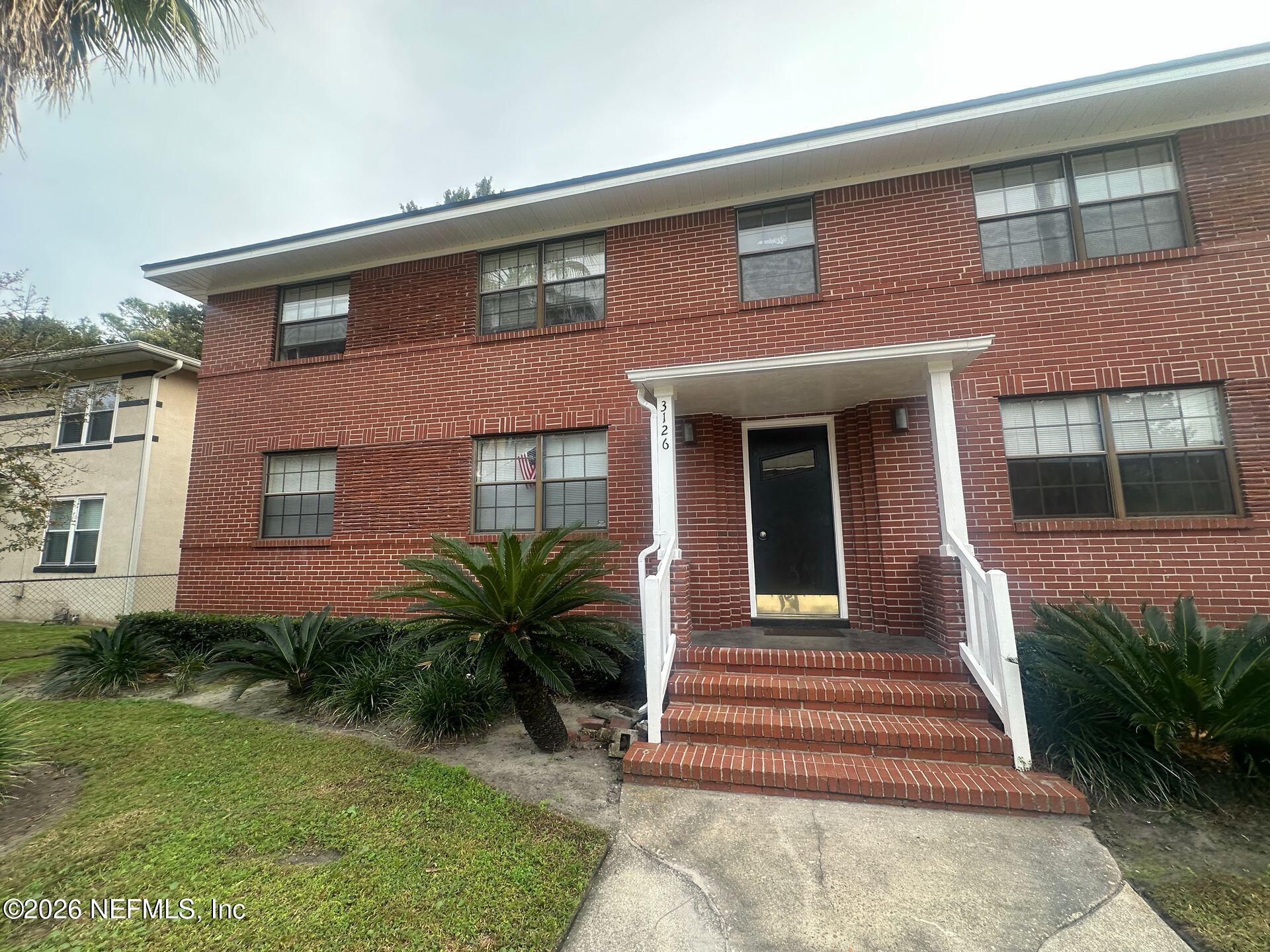 3126 Belden Circle, Unit 3 Jacksonville, FL 32207 - Photo 1 of 15 a view of a house with a yard plants and large tree
