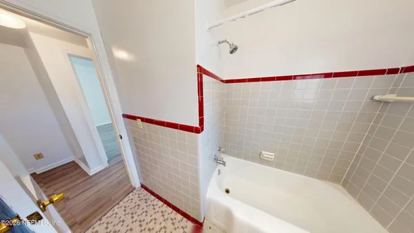 a bathroom with a bathtub and a shower