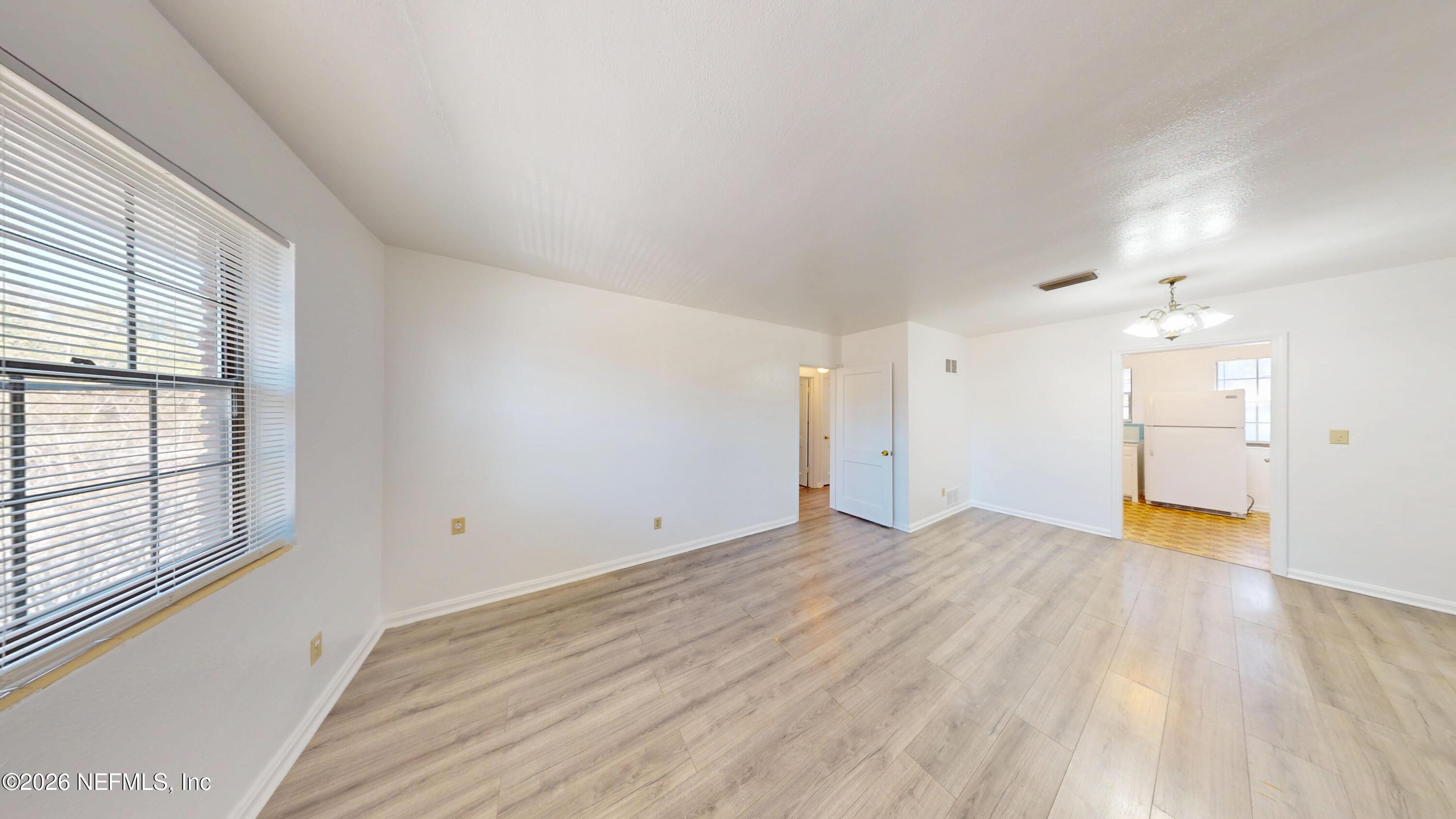 3126 Belden Circle, Unit 3 Jacksonville, FL 32207 - Photo 2 of 15 an empty room with wooden floor and windows