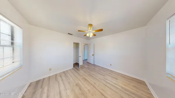 a view of empty room with wooden floor