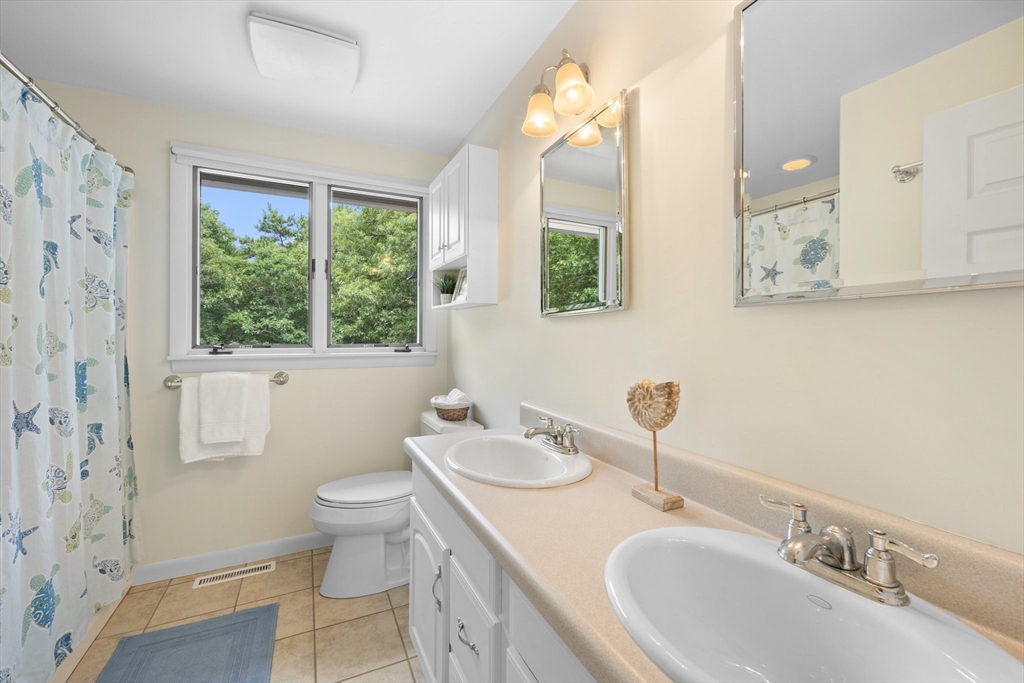 11 Oval Road Chatham, MA 02633 - Photo 14 of 35 a bathroom with a granite countertop sink mirror vanity and toilet