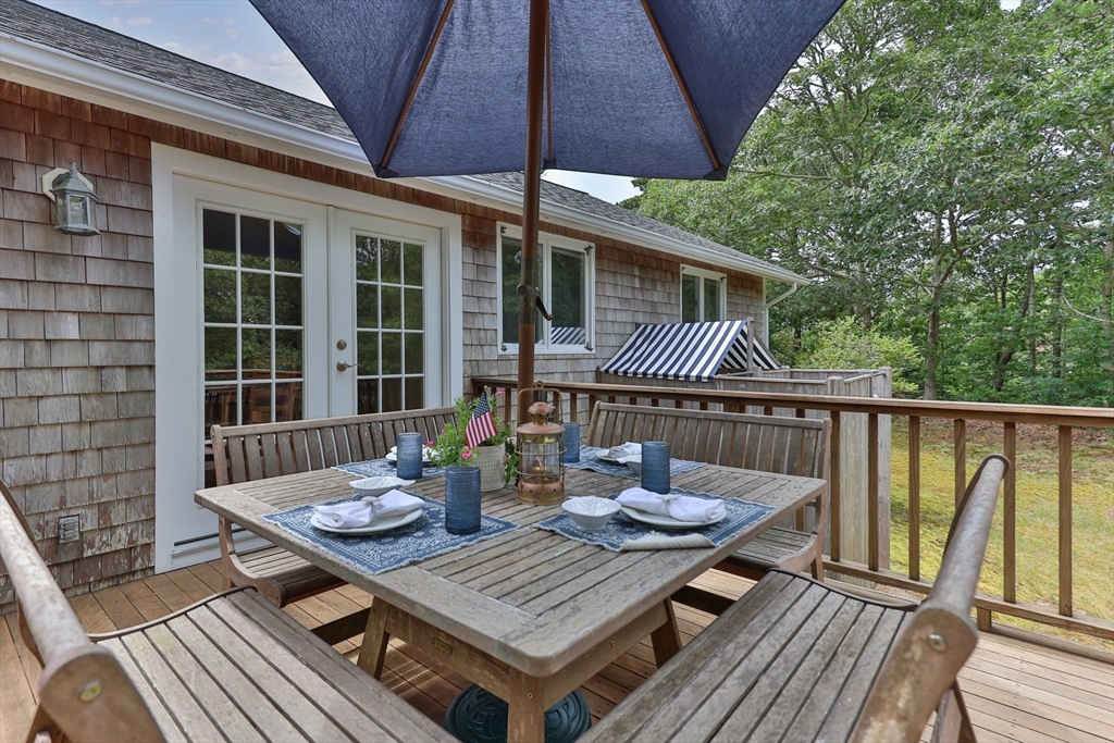 11 Oval Road Chatham, MA 02633 - Photo 16 of 35 a balcony with wooden floor table and chairs