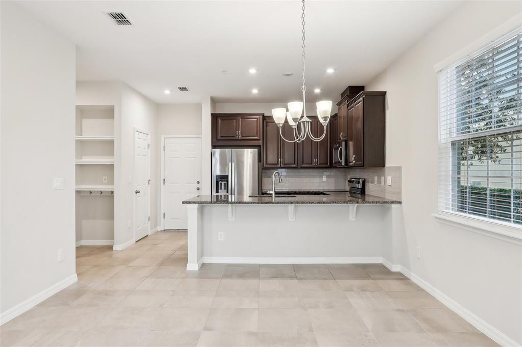 9457 Randal Park Boulevard Orlando, FL 32832 - Photo 12 of 52 a view of a kitchen with a sink and a large window