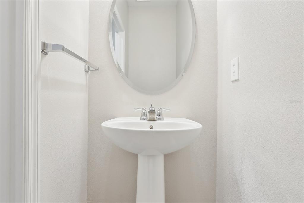 9457 Randal Park Boulevard Orlando, FL 32832 - Photo 17 of 52 a bathroom with a sink a mirror and a shower