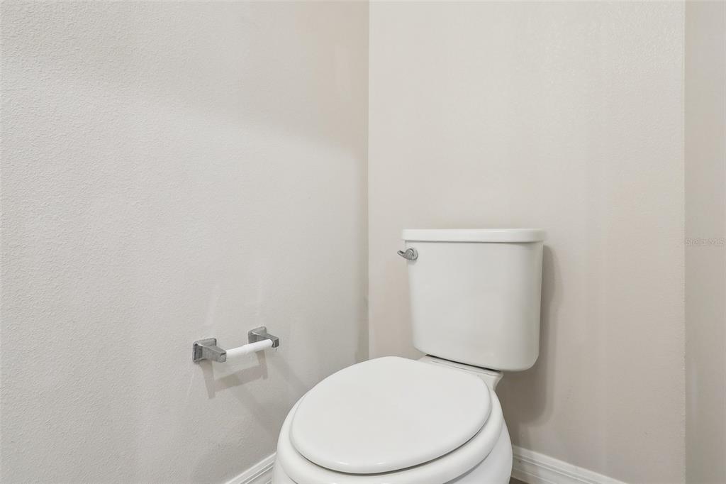 9457 Randal Park Boulevard Orlando, FL 32832 - Photo 18 of 52 a white toilet sitting next to a white wall