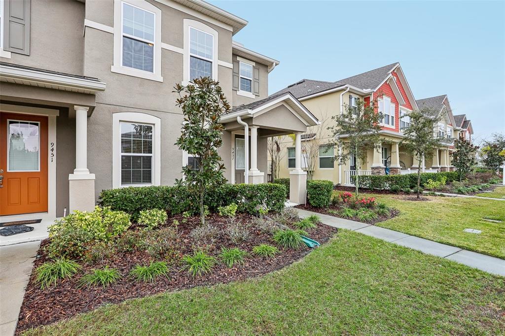 9457 Randal Park Boulevard Orlando, FL 32832 - Photo 3 of 52 a view of a white house with a big yard and potted plants