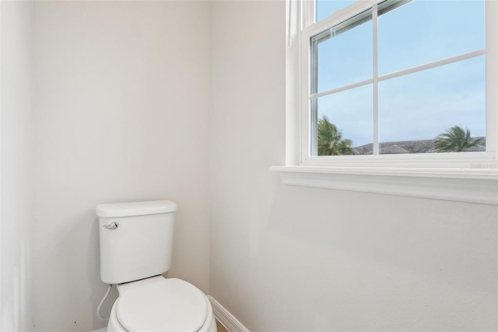 9457 Randal Park Boulevard Orlando, FL 32832 - Photo 33 of 52 a white toilet sitting next to a window