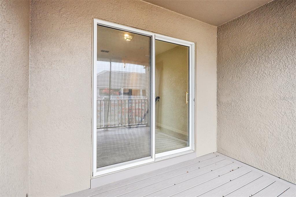 9457 Randal Park Boulevard Orlando, FL 32832 - Photo 35 of 52 an empty room with wooden floor and door