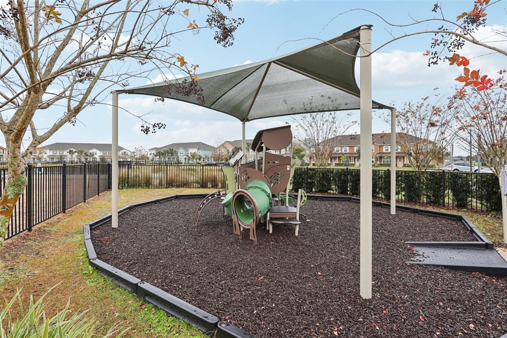 9457 Randal Park Boulevard Orlando, FL 32832 - Photo 41 of 52 a view of a patio with a table chairs and a backyard