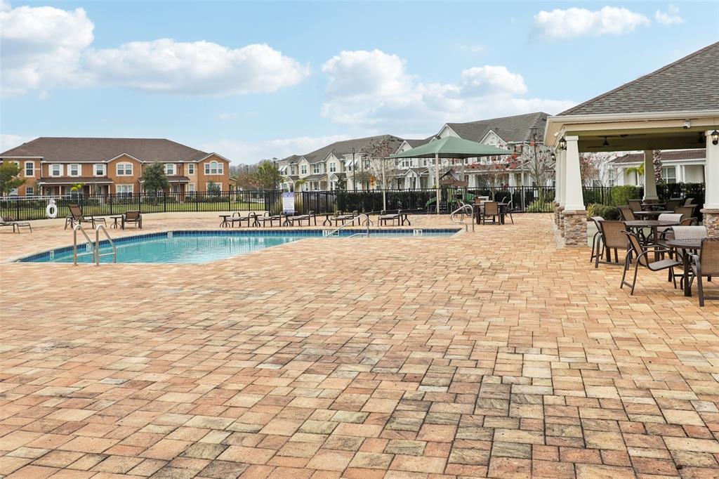 9457 Randal Park Boulevard Orlando, FL 32832 - Photo 46 of 52 a view of swimming pool of water with lawn chairs and plants