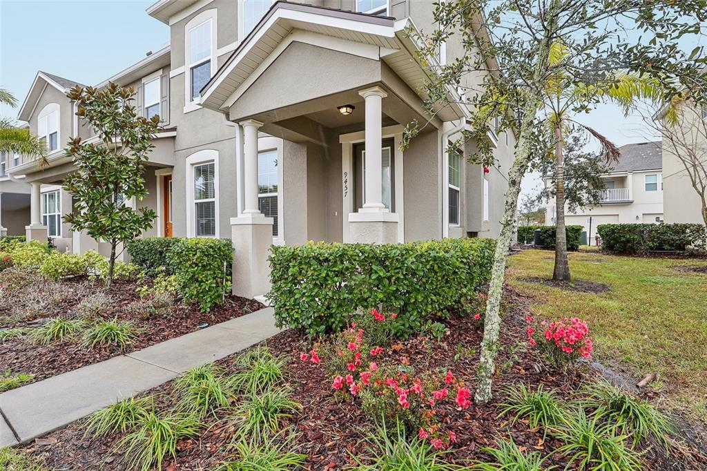 9457 Randal Park Boulevard Orlando, FL 32832 - Photo 5 of 52 a front view of a house with a yard and fountain