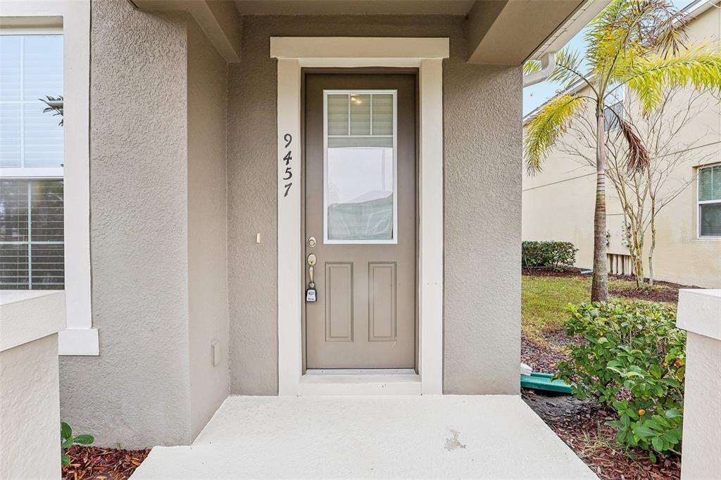 9457 Randal Park Boulevard Orlando, FL 32832 - Photo 6 of 52 a front view of a house with a garden