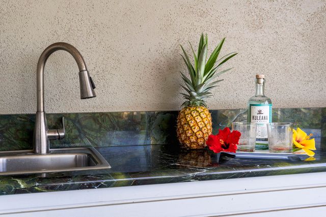 a balcony with wooden floor and outdoor seating