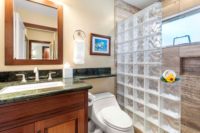 a bedroom with a bed a dresser and a window