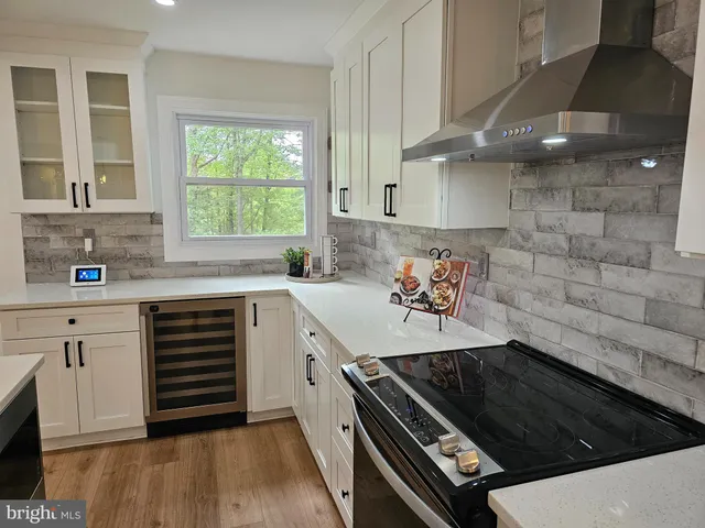 a kitchen with a stove a sink and a microwave