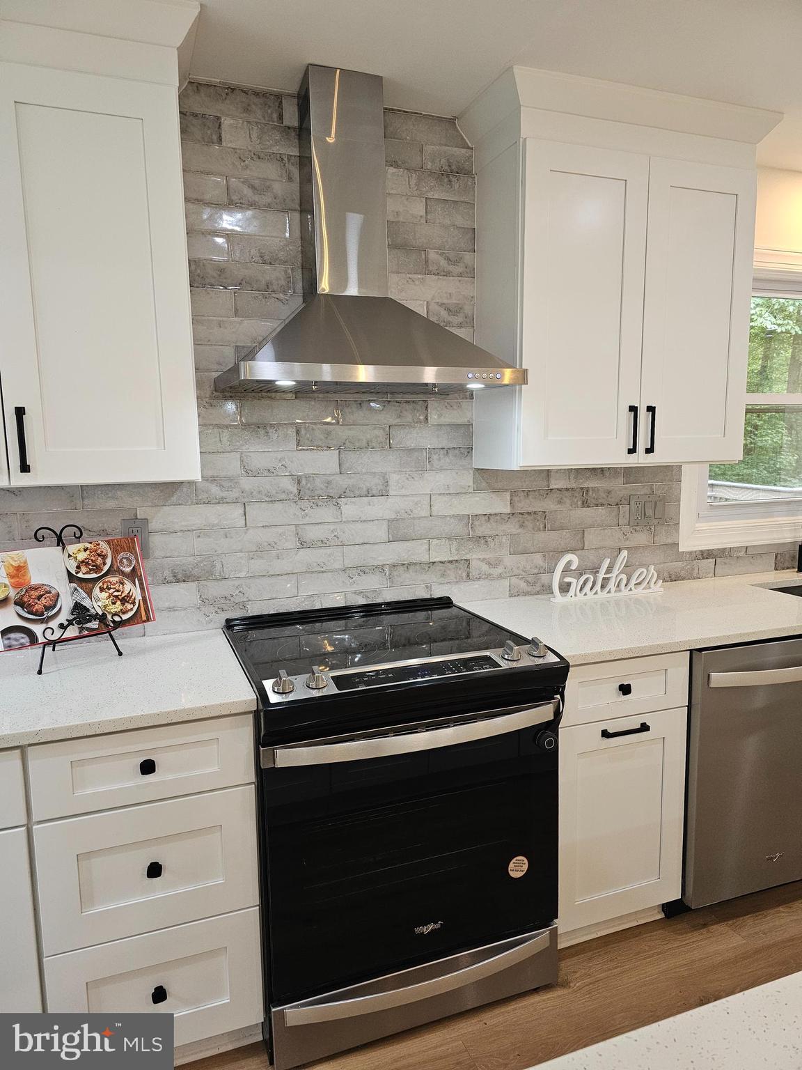 133 Meadows Road Fredericksburg, VA 22406 - Photo 12 of 55 a kitchen with a stove and white cabinets
