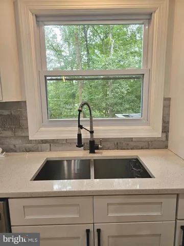 a large kitchen with a table and chairs
