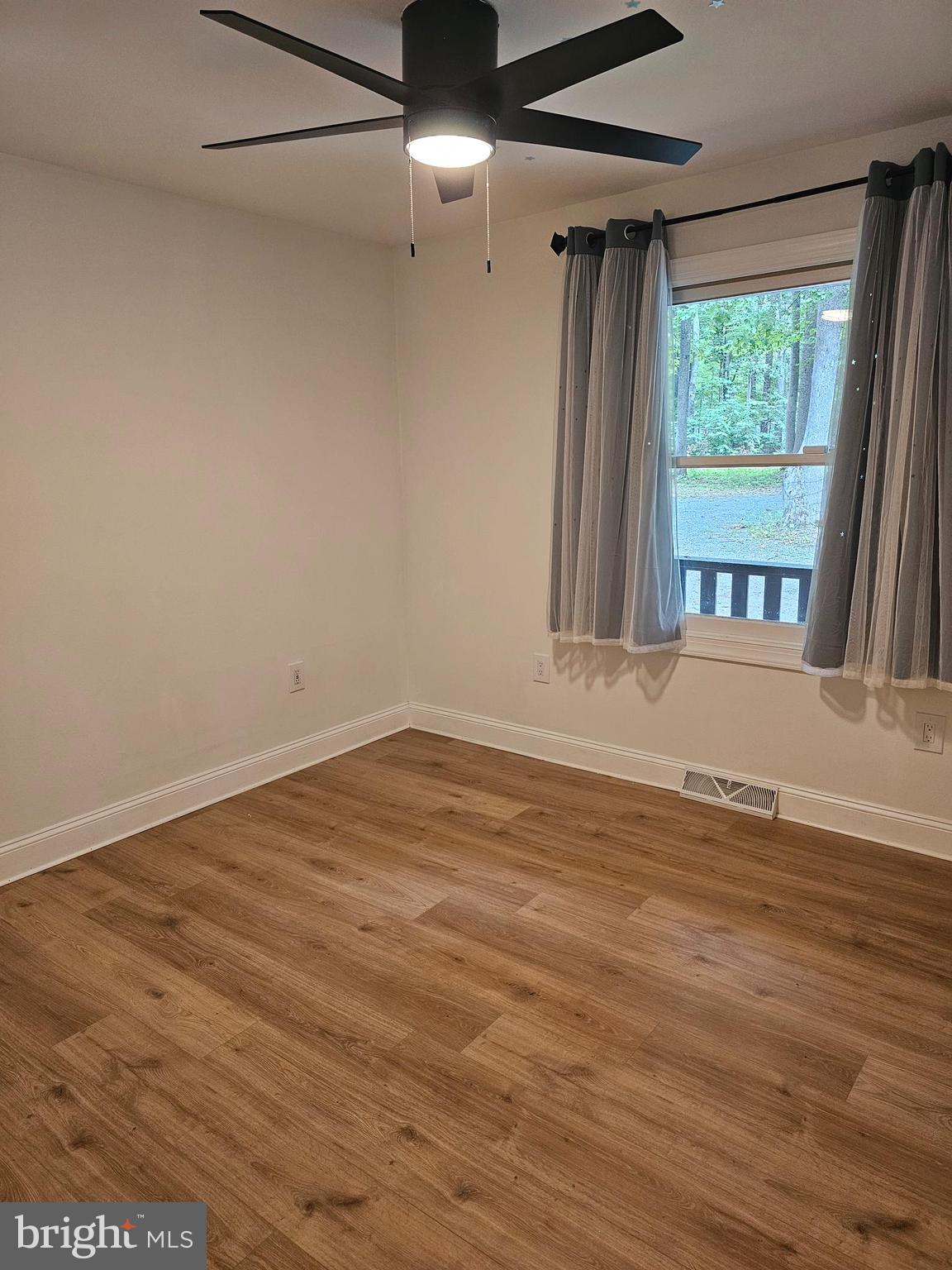 133 Meadows Road Fredericksburg, VA 22406 - Photo 25 of 55 an empty room with wooden floor and windows