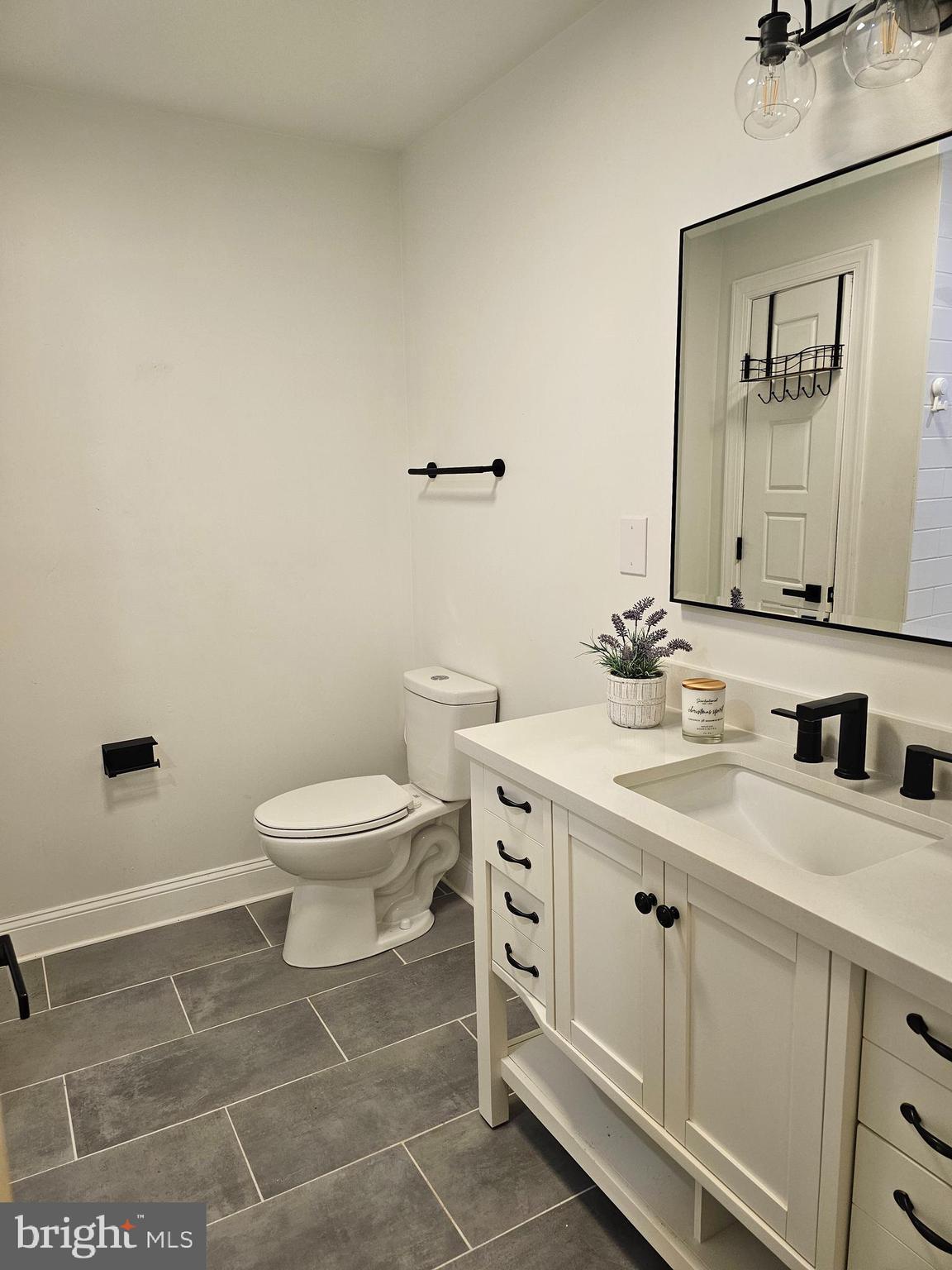 133 Meadows Road Fredericksburg, VA 22406 - Photo 27 of 55 a bathroom with a toilet sink vanity and mirror