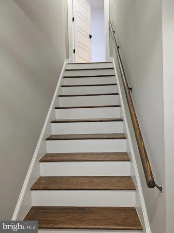 an empty room with wooden floor and closet area
