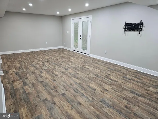 an empty room with wooden floor
