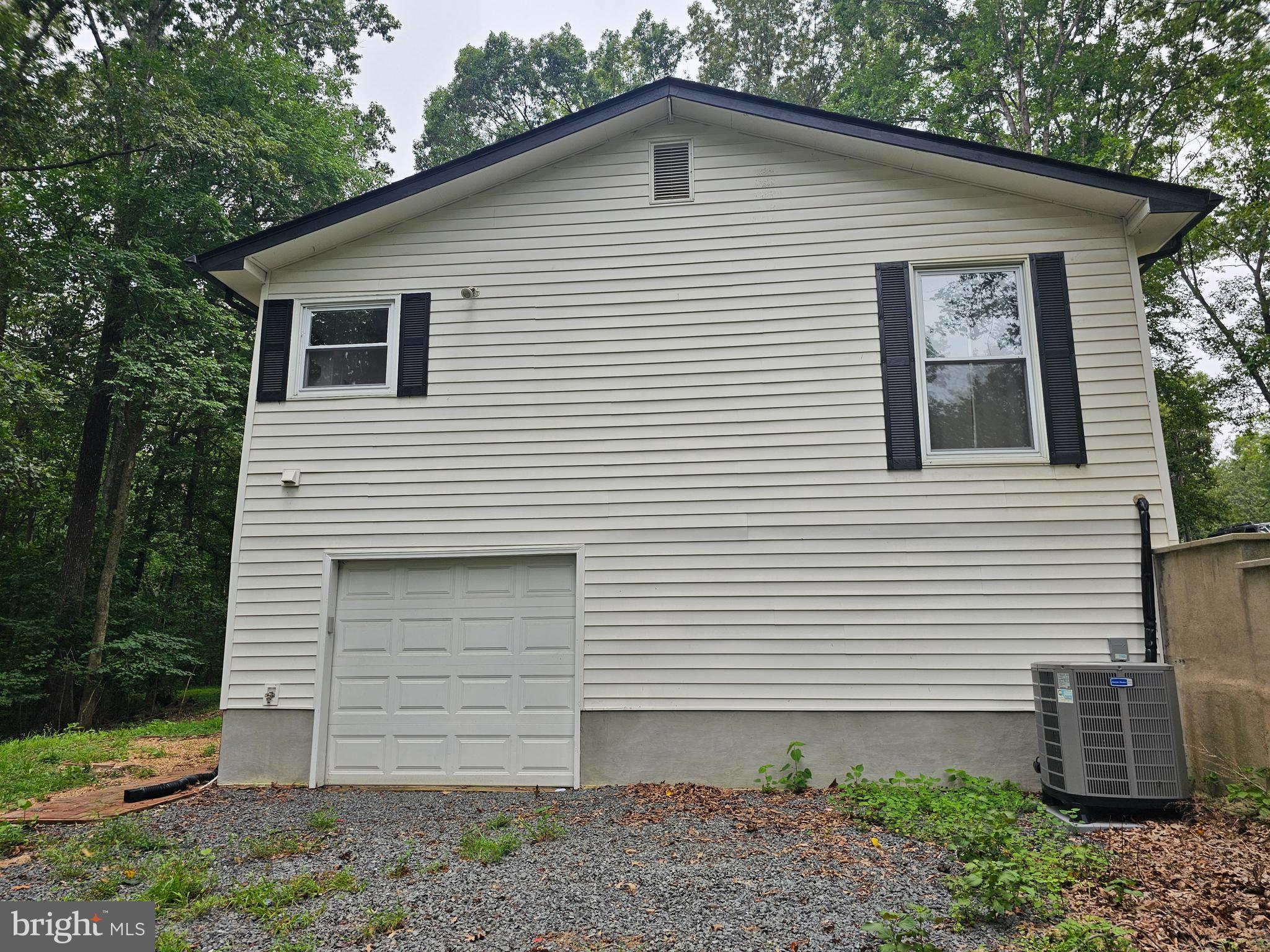 133 Meadows Road Fredericksburg, VA 22406 - Photo 54 of 55 a view of a white house with a small yard and a large window