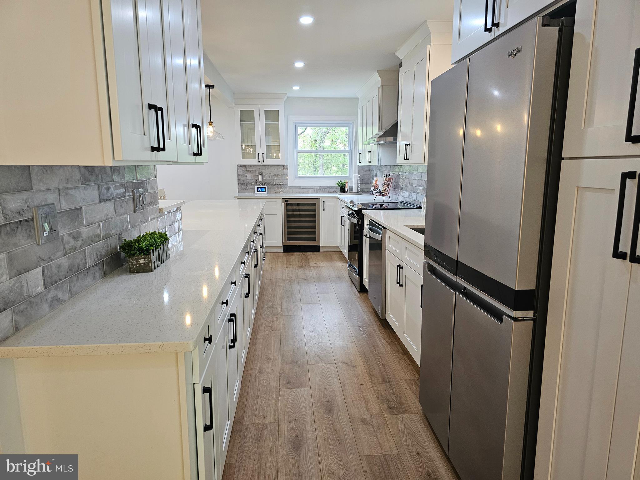 133 Meadows Road Fredericksburg, VA 22406 - Photo 8 of 55 a kitchen with counter top space stainless steel appliances a sink and wooden floor