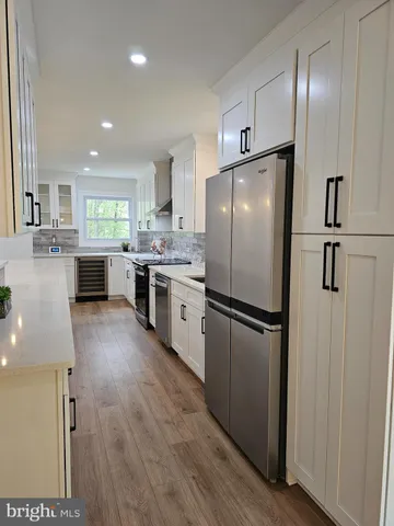 a kitchen with stainless steel appliances a refrigerator sink and cabinets