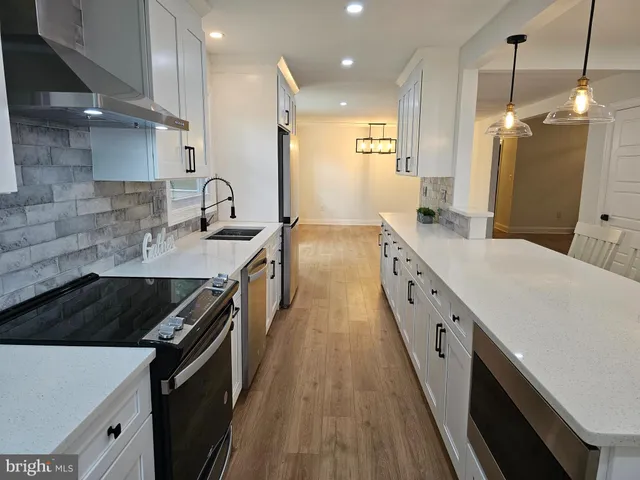 a kitchen with a sink stove and cabinets