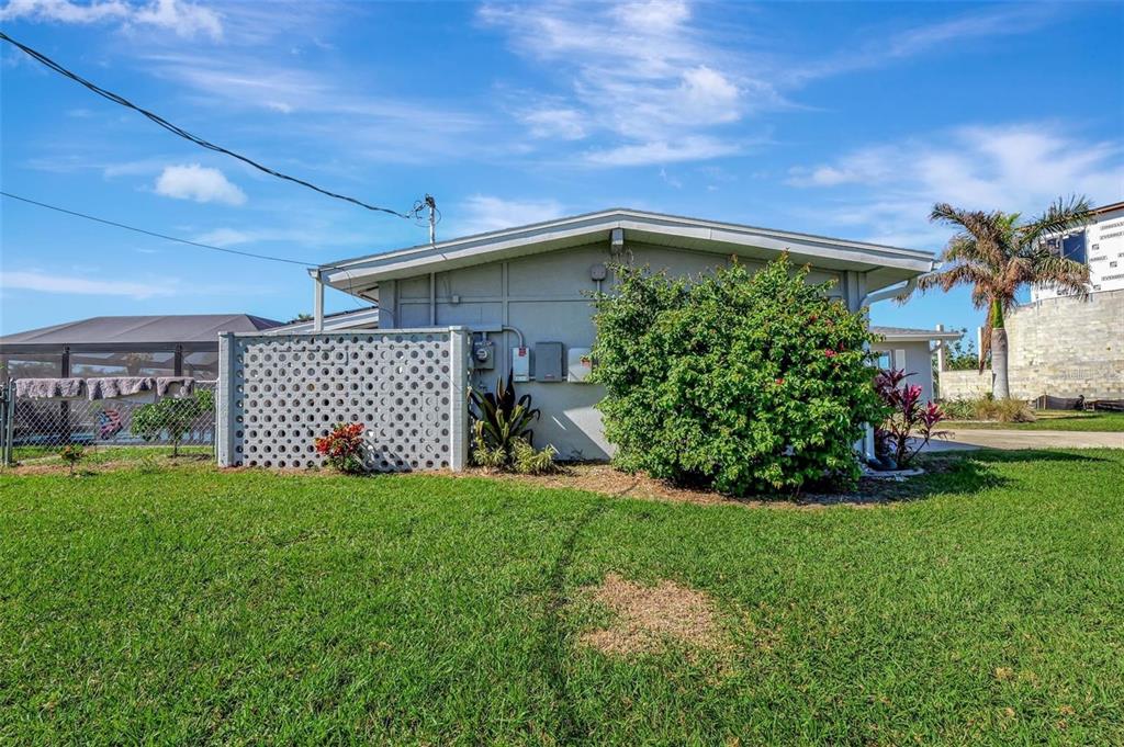 250 Bangsberg Road Southeast Port Charlotte, FL 33952 - Photo 30 of 59 a front view of a house with a yard