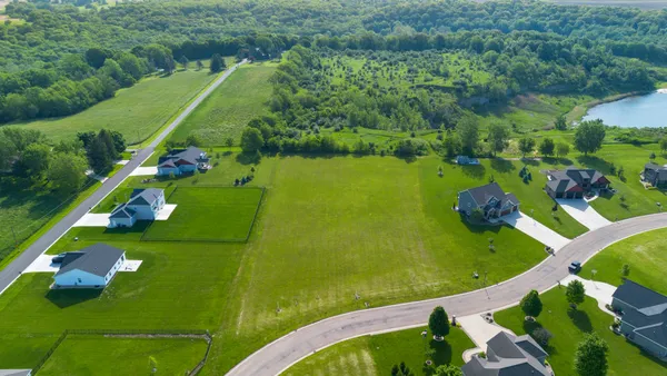 an aerial view of a golf course with a swimming pool