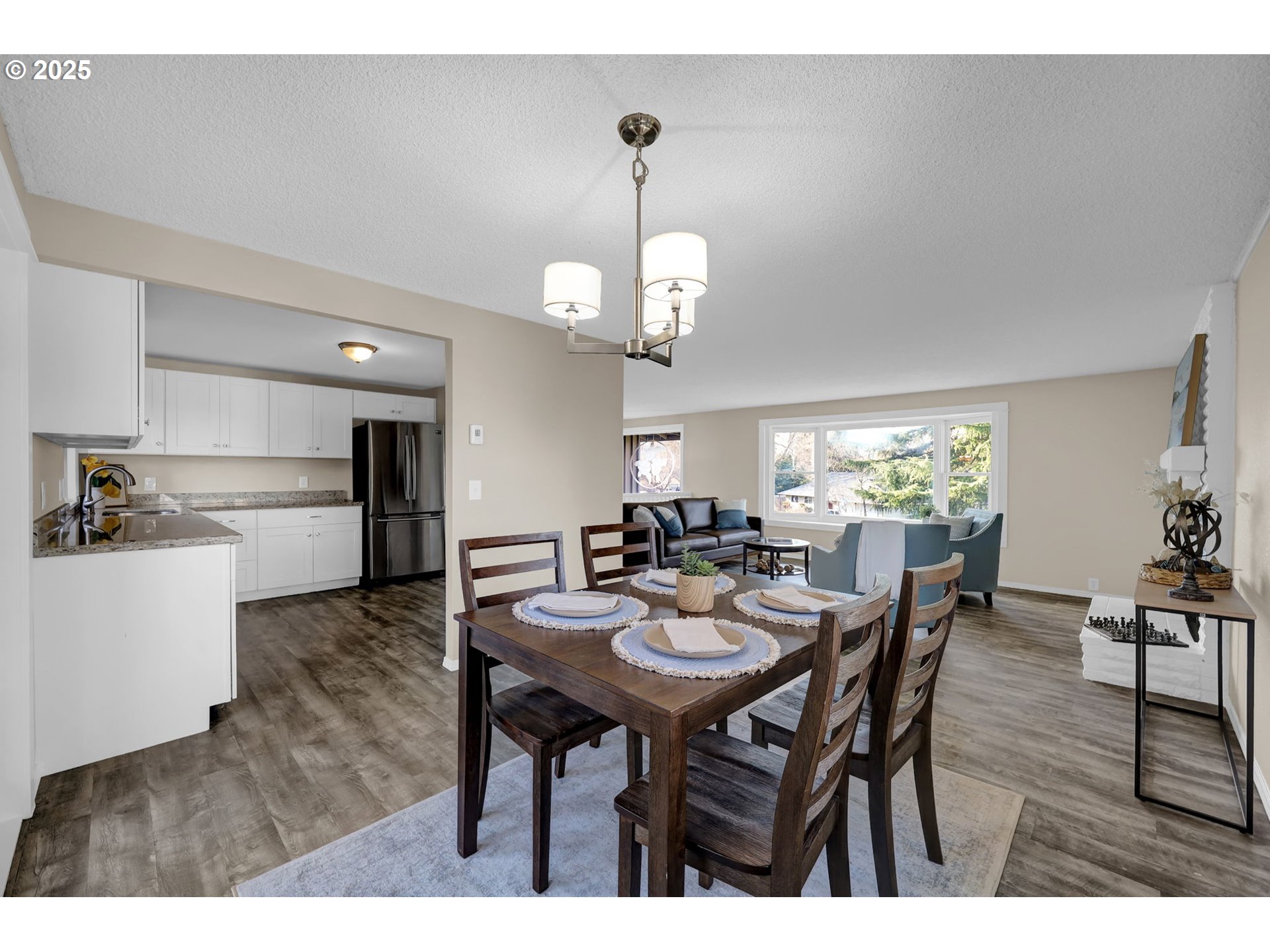 2015 Coventry Way Eugene, OR 97405 - Photo 14 of 48 a view of a dining room and livingroom with furniture wooden floor a chandelier