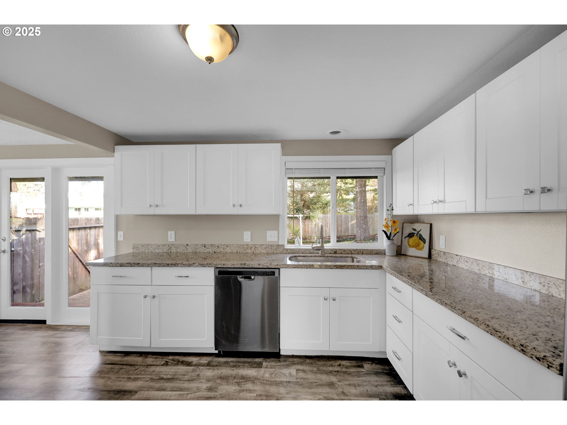 2015 Coventry Way Eugene, OR 97405 - Photo 16 of 48 a kitchen with a sink dishwasher a stove and white cabinets with wooden floor