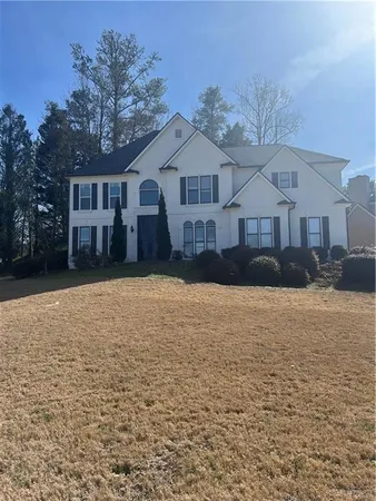 a front view of a house with a yard