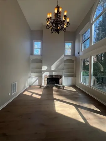 a living room with fireplace furniture and a chandelier