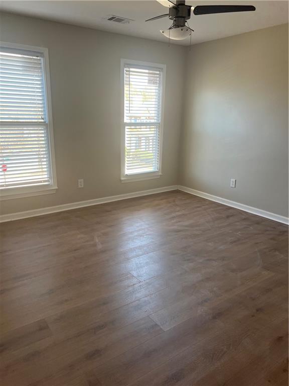 5455 Woodrun Lane Alpharetta, GA 30005 - Photo 37 of 71 an empty room with a window and a ceiling fan