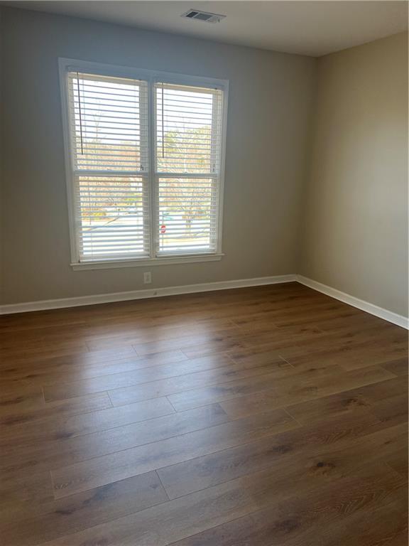 5455 Woodrun Lane Alpharetta, GA 30005 - Photo 42 of 71 an empty room with wooden floor and windows