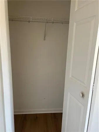 a view of a room with wooden floor and a window
