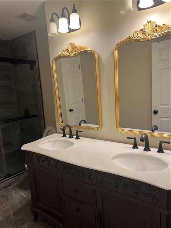 5455 Woodrun Lane Alpharetta, GA 30005 - Photo 45 of 71 a bathroom with double vanity sinks and a mirror