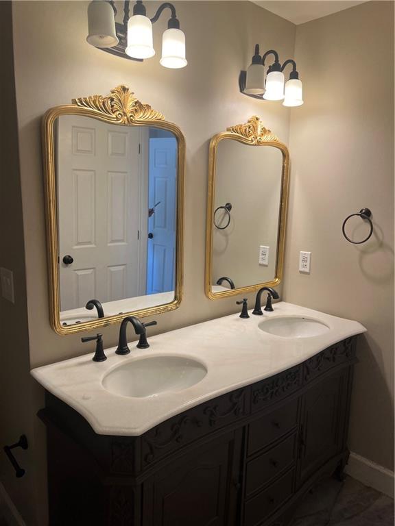 5455 Woodrun Lane Alpharetta, GA 30005 - Photo 47 of 71 a bathroom with a double vanity sink and a mirror