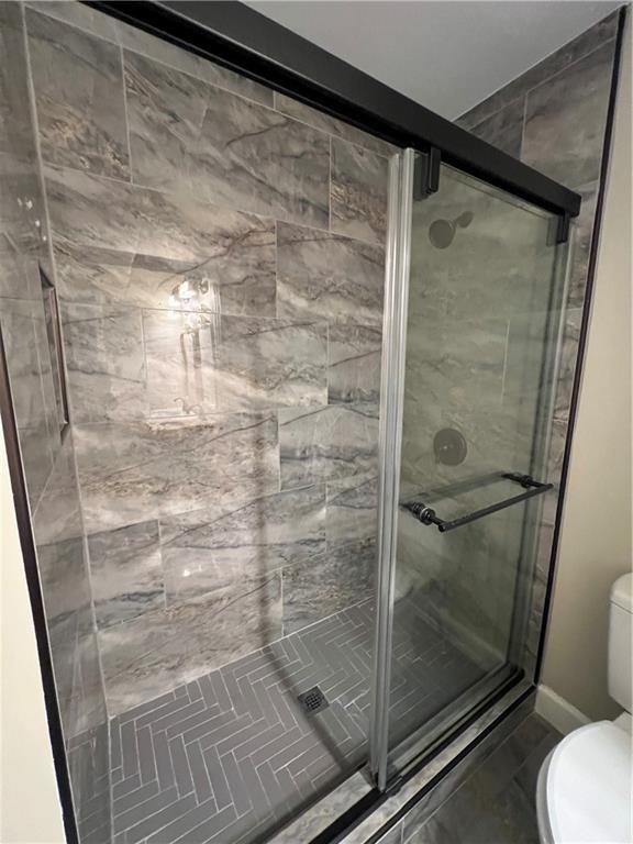 5455 Woodrun Lane Alpharetta, GA 30005 - Photo 48 of 71 a bathroom with a glass shower door