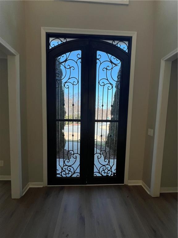 5455 Woodrun Lane Alpharetta, GA 30005 - Photo 5 of 71 a view of front door with wooden floor