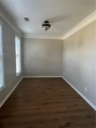 a view of a room with wooden floor and window