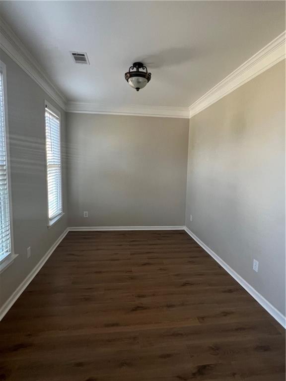 5455 Woodrun Lane Alpharetta, GA 30005 - Photo 7 of 71 a view of an empty room with wooden floor and a window